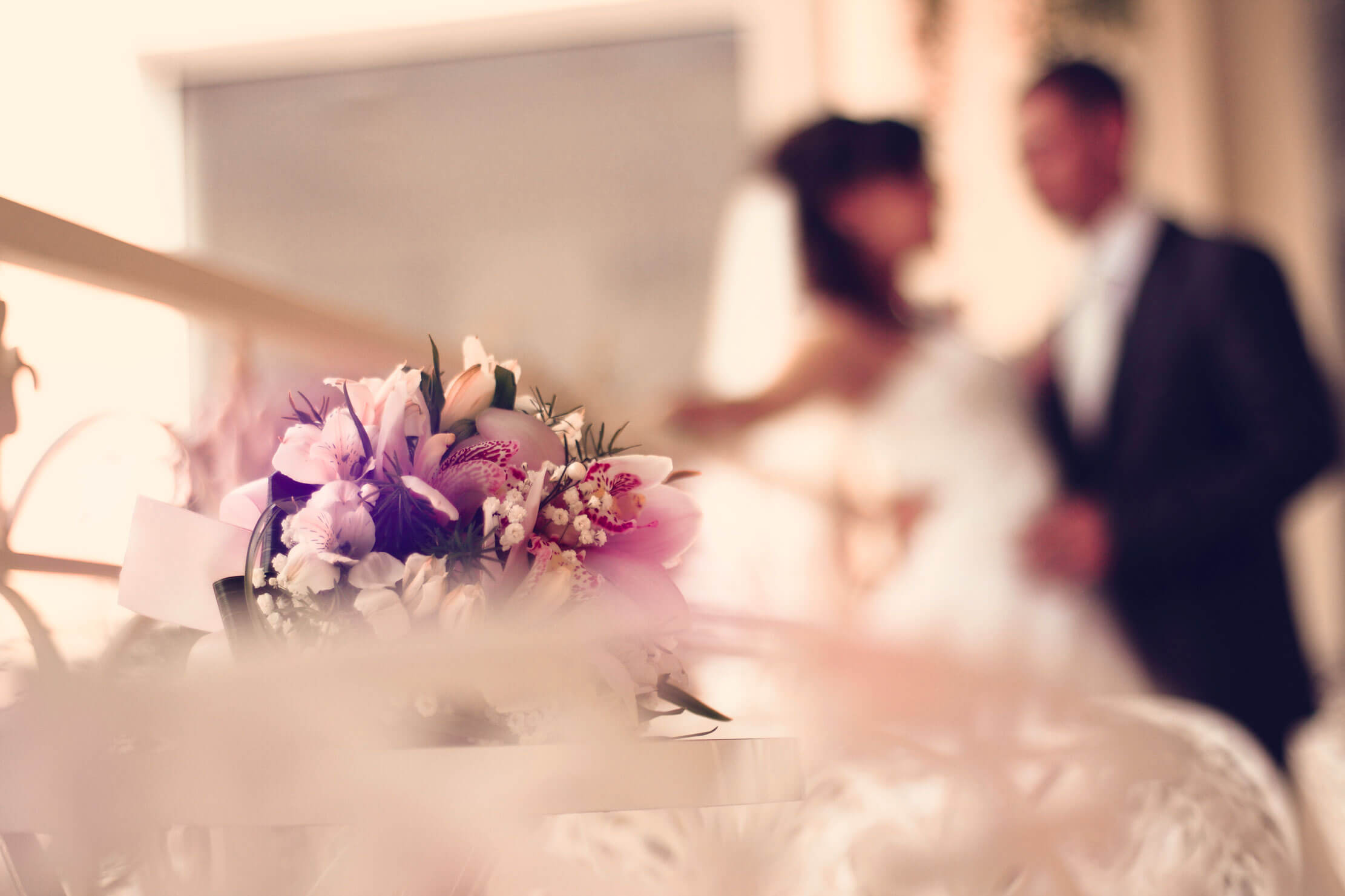 Wedding Flowers and the happy couple behind them.